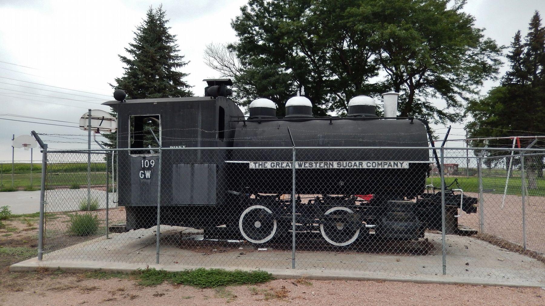 GW Steam Locomotive Black locomotive steam engine behind a chain link fence