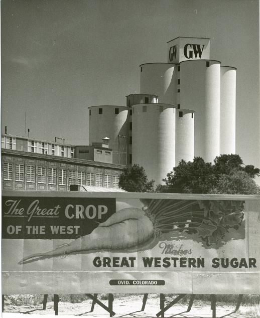 A black and white photo of the GW Sugar Factory building and Silos with the GW logo displayed on the tallest one.