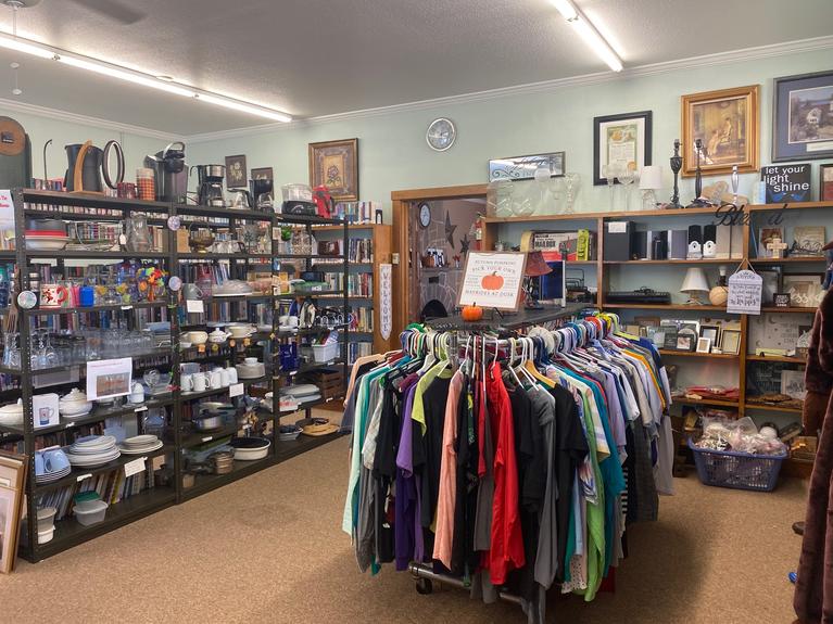 A small room with used housewares and clothing available for sale